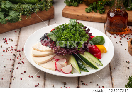 Fresh vegetable and cheese platter with herbs 128937212