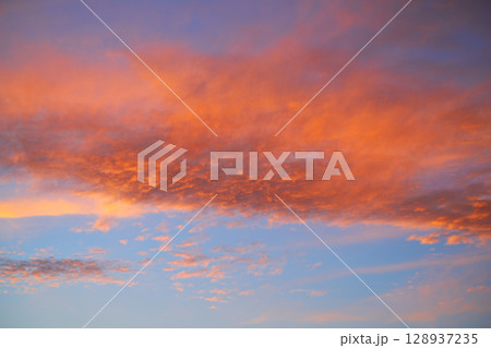 Sunset sky with orange clouds and blue 128937235