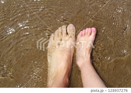 father and children feet on summer sand beach father and children feet on summer sand beach 128937276