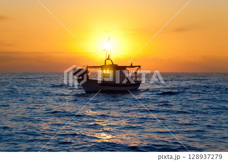 fishing boat in sunrise at Mediterranean sea 128937279
