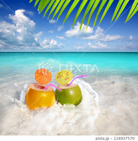 coconut cocktails juice in tropical beach water splash coconut cocktails juice in tropical beach water splash 128937570