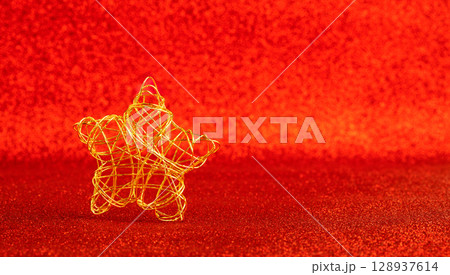 christmas gold wire star on red glitter christmas gold wire star on red glitter 128937614