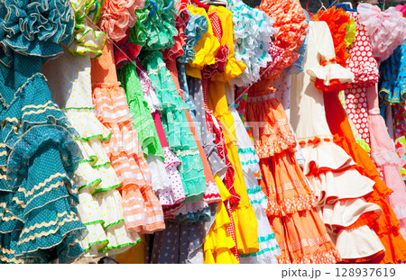 colorful gipsy dresses in rack hanged in Spain colorful gipsy dresses in rack hanged in Spain 128937619