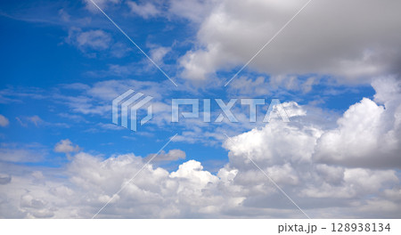 Blue summer sky with cumulus clouds 128938134