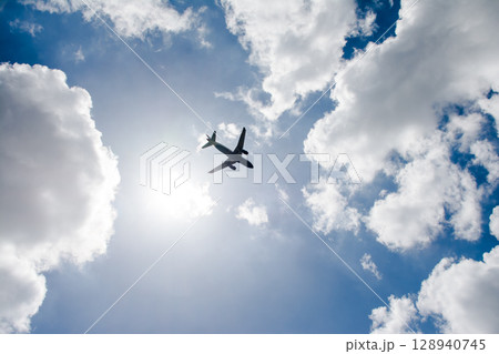 青空の下を上昇していく旅客機 ロンドン郊外のヒースロー空港近くにて 青空の下を上昇していく旅客機 ロンドン郊外のヒースロー空港近くにて 128940745