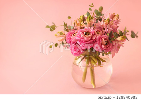 Summer blossoming delicate ranunculus on blooming flowers festive background, pastel and soft pink bouquet floral card, selective focus 128940985