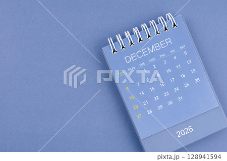 December 2026 calendar on blue color background. Desk calendar for planning and organizing. December 2026 calendar on blue color background. Desk calendar for planning and organizing. 128941594