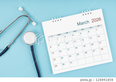 March 2026 desk calendar and stethoscope on blue color, Medical appointment concept. 128941859