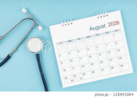 August 2026 desk calendar and stethoscope on blue color, Medical appointment concept. 128941864