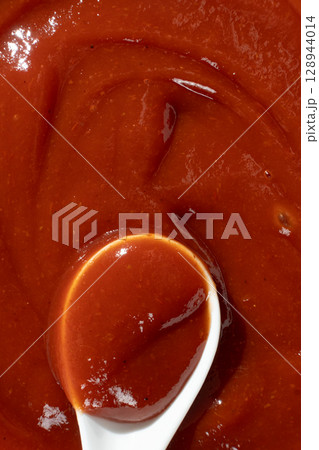 Traditional Ketchup in Spoon Macro. Organic Culinary Element. 128944014