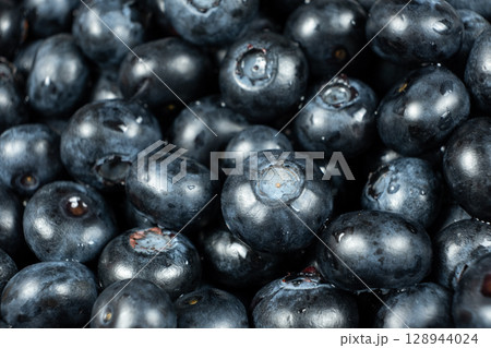Fresh blueberries in drops of water close-up, berry background Fresh blueberries in drops of water close-up, berry background 128944024