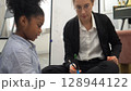 African kid with caucasian teacher diversity fun interactive learning environment school 128944122