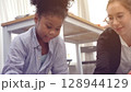 African kid with caucasian teacher diversity fun interactive learning environment school 128944129
