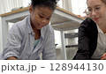 African kid with caucasian teacher diversity fun interactive learning environment school 128944130