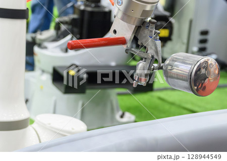 Close up scene the spray painting robot working with automotive parts. 128944549