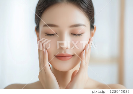 目を閉じて肌をいたわる美しい女性のスキンケアイメージ 目を閉じて肌をいたわる美しい女性のスキンケアイメージ 128945085