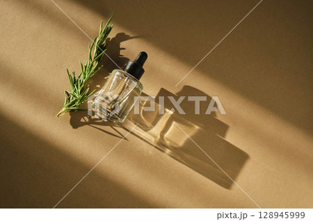 Natural facial oil with beautiful highlights on a beige background. Natural facial oil with beautiful highlights on a beige background. 128945999