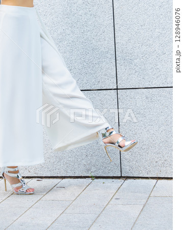 Woman wearing high heels and culottes Woman wearing high heels and culottes 128946076