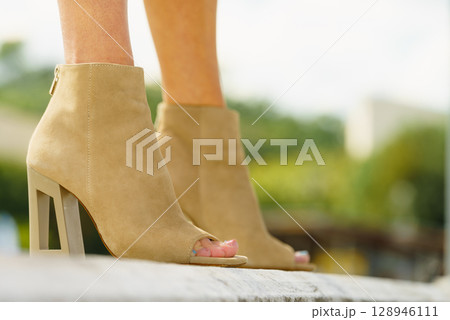 Woman wearing suede brown high heels Woman wearing suede brown high heels 128946111