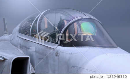 Close up of modern aircraft military fighter jet. Close up Jet parts such as landing gear engine nacelles weapon pods and cockpit with visible pilots showing defense technology and aircraft design. 128946550