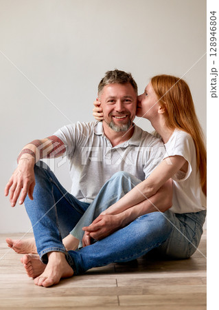 Happy couple sharing a joyful moment together in a bright indoor setting 128946804