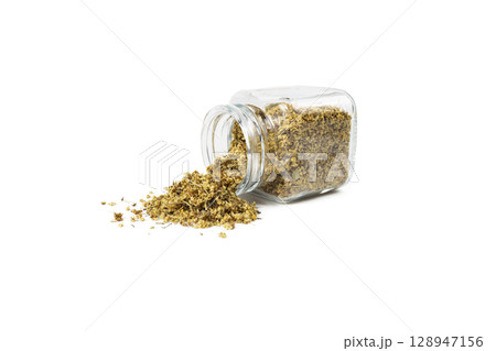 dried flowers of black lilac or black elder in latin sambuci flos falling from glass jar isolated on white background. 128947156
