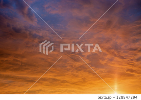 Golden sunrise sky with dramatic clouds Golden sunrise sky with dramatic clouds 128947294