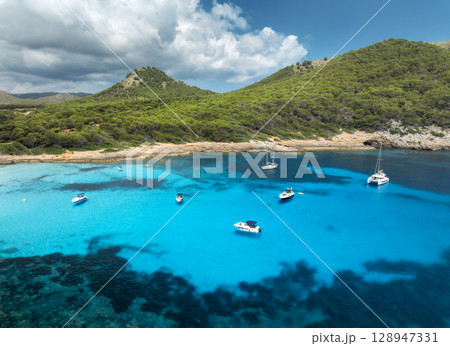 Aerial view of luxury yachts and speed boats on blue sea 128947331