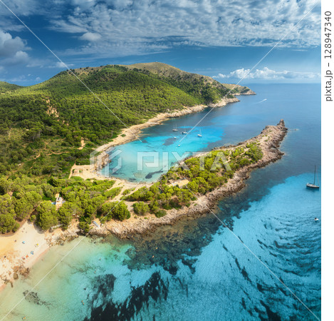 Aerial view of Cala Agulla beach, turquoise water, white sand Aerial view of Cala Agulla beach, turquoise water, white sand 128947340
