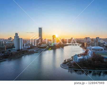 Yekaterinburg aerial panoramic view in spring at sunset. Yekaterinburg city and pond in spring or autumn. 128947949