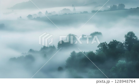 The soft morning mist blankets the landscape in a serene gradient of powder blue pale green and dove grey giving it a mystical quality 128948764
