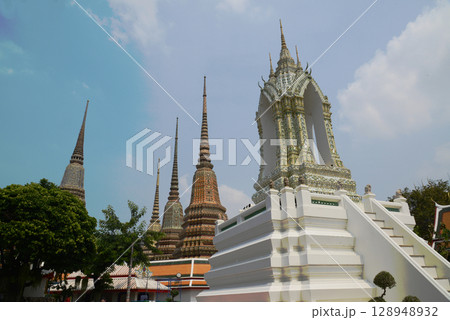Classic Thai architecture with pagoda in Wat Phra Chetuphon or Wat Pho. Which is one of the largest and oldest temples and is popular with both Thai and foreign tourists. Located at Bangkok city. Classic Thai architecture with pagoda in Wat Phra Chetuphon or Wat Pho. Which is one of the largest and oldest temples and is popular with both Thai and foreign tourists. Located at Bangkok city. 128948932