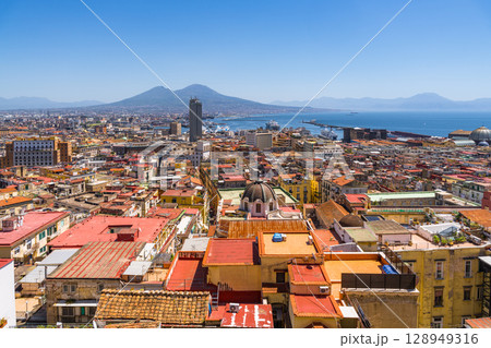Naples cityscape with Mount Vesuvius in background, showcasing Italian urban landscape Naples cityscape with Mount Vesuvius in background, showcasing Italian urban landscape 128949316