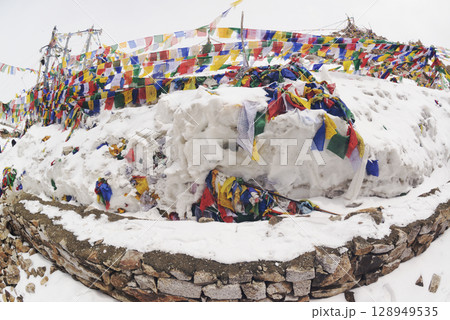 Prayer flags at a small religious site at Khardung La. This pass is located in the Ladakh mountains north of Leh and connects the Indus and Shyok river valleys and is the highest motorable road. Prayer flags at a small religious site at Khardung La. This pass is located in the Ladakh mountains north of Leh and connects the Indus and Shyok river valleys and is the highest motorable road. 128949535