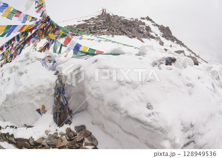 Prayer flags at a small religious site at Khardung La. This pass is located in the Ladakh mountains north of Leh and connects the Indus and Shyok river valleys and is the highest motorable road. Prayer flags at a small religious site at Khardung La. This pass is located in the Ladakh mountains north of Leh and connects the Indus and Shyok river valleys and is the highest motorable road. 128949536