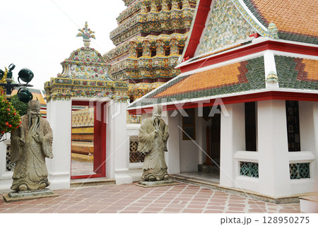 Beautiful Thai architecture of pagoda and building at Wat Phra Chetuphon or Wat Pho, which is an important temple, is large and has many Buddhists and tourists visiting. At Bangkok city in Thailand. 128950275