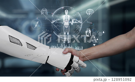 Close up of robot and human shake hands with human anatomy hologram. Salubrious. Close up of robot and human shake hands with human anatomy hologram. Salubrious. 128951092