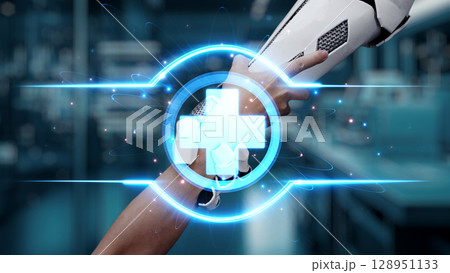 Close up of hand reaching and holding robotic arm with cross icon. Salubrious. Close up of hand reaching and holding robotic arm with cross icon. Salubrious. 128951133