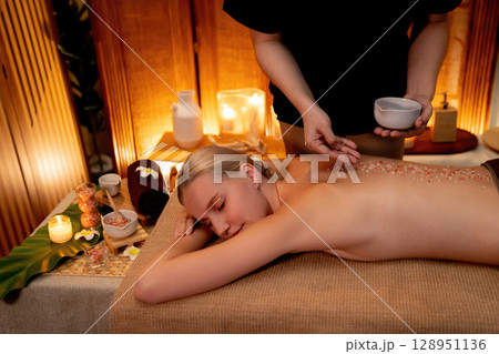 Woman customer having exfoliation treatment in luxury spa. Quiescent 128951136