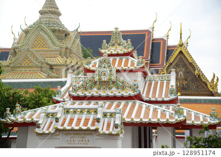 Classic Thai architecture mixed with Chinese art at Wat Phra Chetuphon or Wat Pho, one of the largest and oldest temples and a popular destination for both Thai and foreign tourists. Classic Thai architecture mixed with Chinese art at Wat Phra Chetuphon or Wat Pho, one of the largest and oldest temples and a popular destination for both Thai and foreign tourists. 128951174