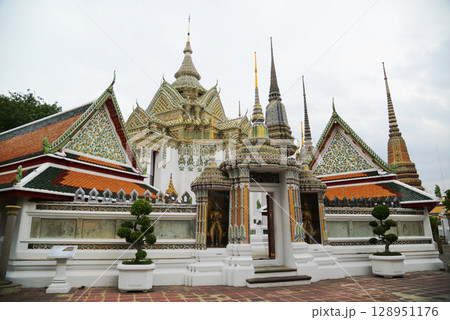 Beautiful Thai architecture of pagoda and building at Wat Phra Chetuphon or Wat Pho, which is an important temple, is large and has many Buddhists and tourists visiting. At Bangkok city in Thailand. Beautiful Thai architecture of pagoda and building at Wat Phra Chetuphon or Wat Pho, which is an important temple, is large and has many Buddhists and tourists visiting. At Bangkok city in Thailand. 128951176