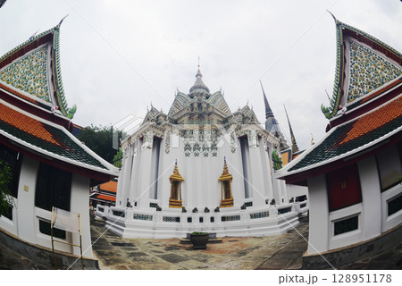 Beautiful Thai architecture of pagoda and building at Wat Phra Chetuphon or Wat Pho, which is an important temple, is large and has many Buddhists and tourists visiting. At Bangkok city in Thailand. Beautiful Thai architecture of pagoda and building at Wat Phra Chetuphon or Wat Pho, which is an important temple, is large and has many Buddhists and tourists visiting. At Bangkok city in Thailand. 128951178
