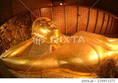 The Reclining Buddha Gold Statue. This Buddha is 46 m long and 15 m highest is located in Wat Pho Bangkok. There are many Buddhists and tourists who come to visit. The Reclining Buddha Gold Statue. This Buddha is 46 m long and 15 m highest is located in Wat Pho Bangkok. There are many Buddhists and tourists who come to visit. 128951371