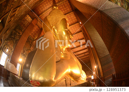 The Reclining Buddha Gold Statue. This Buddha is 46 m long and 15 m highest is located in Wat Pho Bangkok. There are many Buddhists and tourists who come to visit. The Reclining Buddha Gold Statue. This Buddha is 46 m long and 15 m highest is located in Wat Pho Bangkok. There are many Buddhists and tourists who come to visit. 128951373