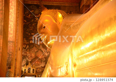 The Reclining Buddha Gold Statue. This Buddha is 46 m long and 15 m highest is located in Wat Pho Bangkok. There are many Buddhists and tourists who come to visit. The Reclining Buddha Gold Statue. This Buddha is 46 m long and 15 m highest is located in Wat Pho Bangkok. There are many Buddhists and tourists who come to visit. 128951374