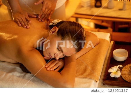 Caucasian woman customer enjoying relaxing anti-stress massage. Quiescent Caucasian woman customer enjoying relaxing anti-stress massage. Quiescent 128951387