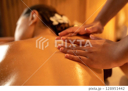 Closeup woman customer enjoying relaxing anti-stress massage. Quiescent Closeup woman customer enjoying relaxing anti-stress massage. Quiescent 128951442