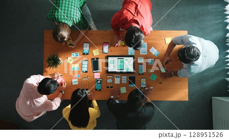 Top view of developer team working together to write idea on note. Convocation. Top view of developer team working together to write idea on note. Convocation. 128951526