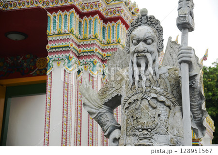 Chinese guardian statue at the gate of Wat Pho Which is one of the largest and oldest temples in Bangkok and is popular with both Thai and foreign tourists. 128951567