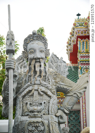 Chinese guardian statue at the gate of Wat Pho Which is one of the largest and oldest temples in Bangkok and is popular with both Thai and foreign tourists. 128951570